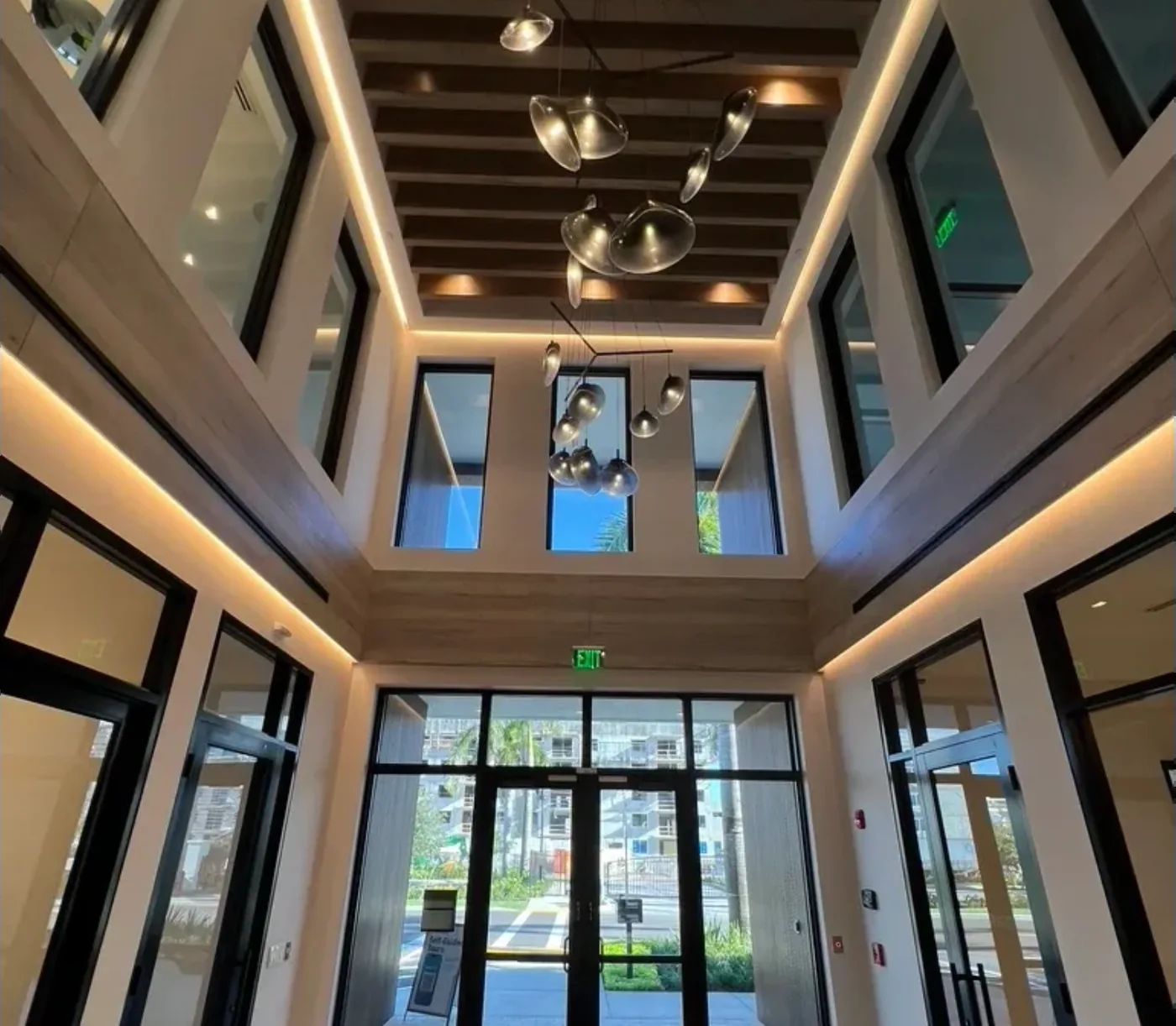 Two-story apartment lobby with clean glass doors and windows after a final clean